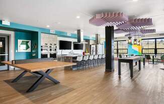 Pingpong table next to an open concept kitchen with seating around the island