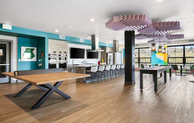 Pingpong table next to an open concept kitchen with seating around the island