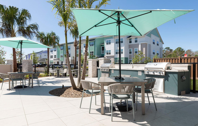 picnic tables and umbrellas beside luxury grilling areas at Lake Nona Concorde