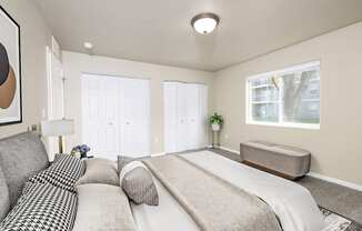 A bedroom with a large bed and a window.