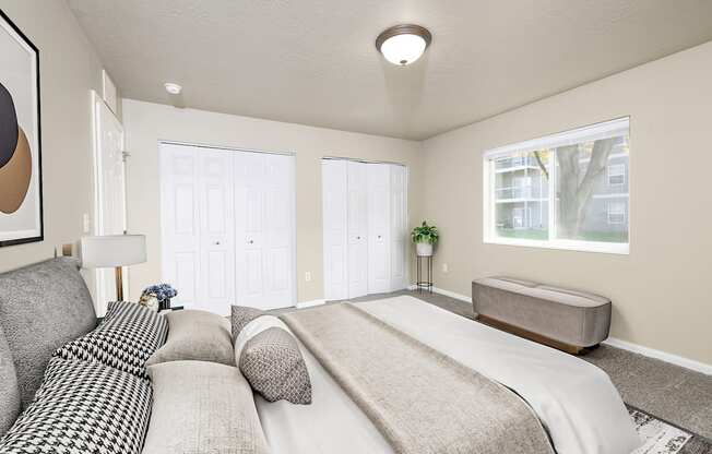 A bedroom with a large bed and a window.