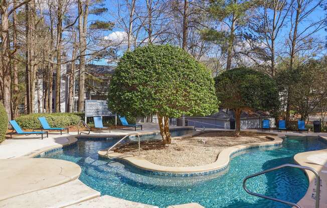 a swimming pool with a tree in the middle of it