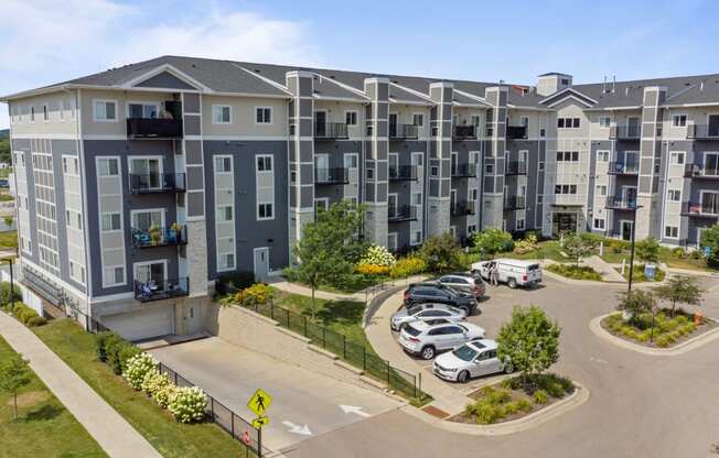 an aerial view of an apartment complex with cars parked in a parking lot