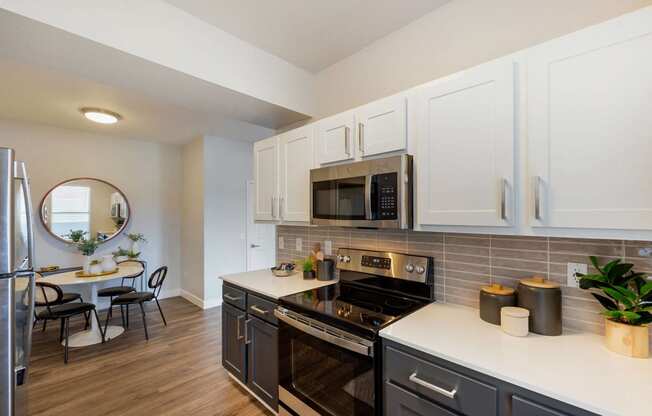 a kitchen with stainless steel appliances and white cabinets at Paisley and Pointe Apartments, Las Vegas, NV 89130
