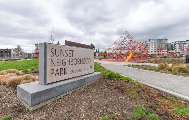 A sign for Sunset Neighborhood Park is in front of a construction site.