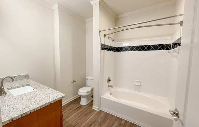 Apartment Home Bathroom with Wood Style Plank Flooring and Vanity located in Lawrenceville, GA