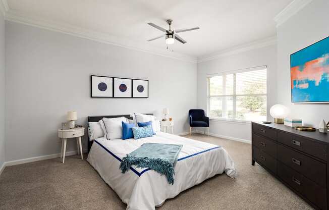 a bedroom with a bed and a ceiling fan