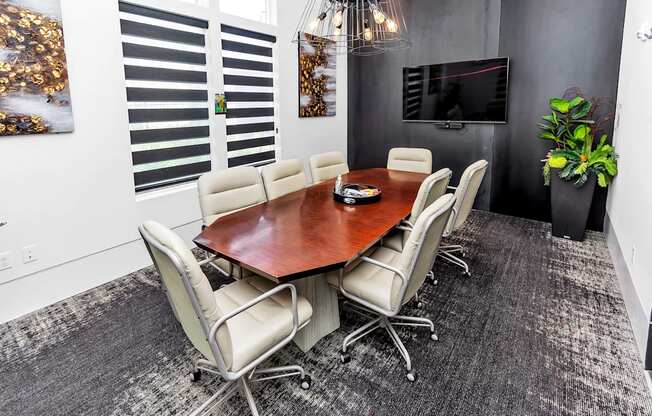 a conference room with a table and chairs