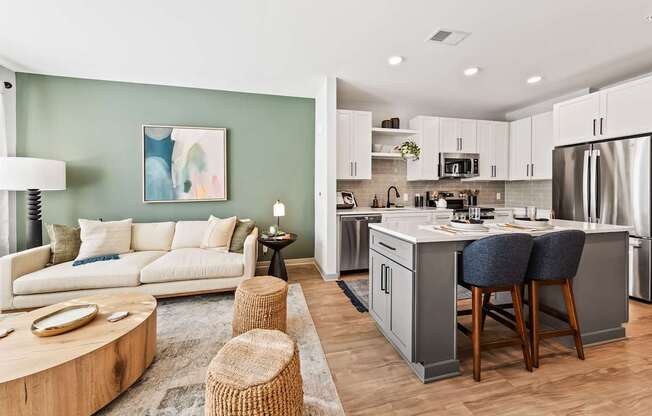 A modern kitchen with a breakfast bar and a living room area