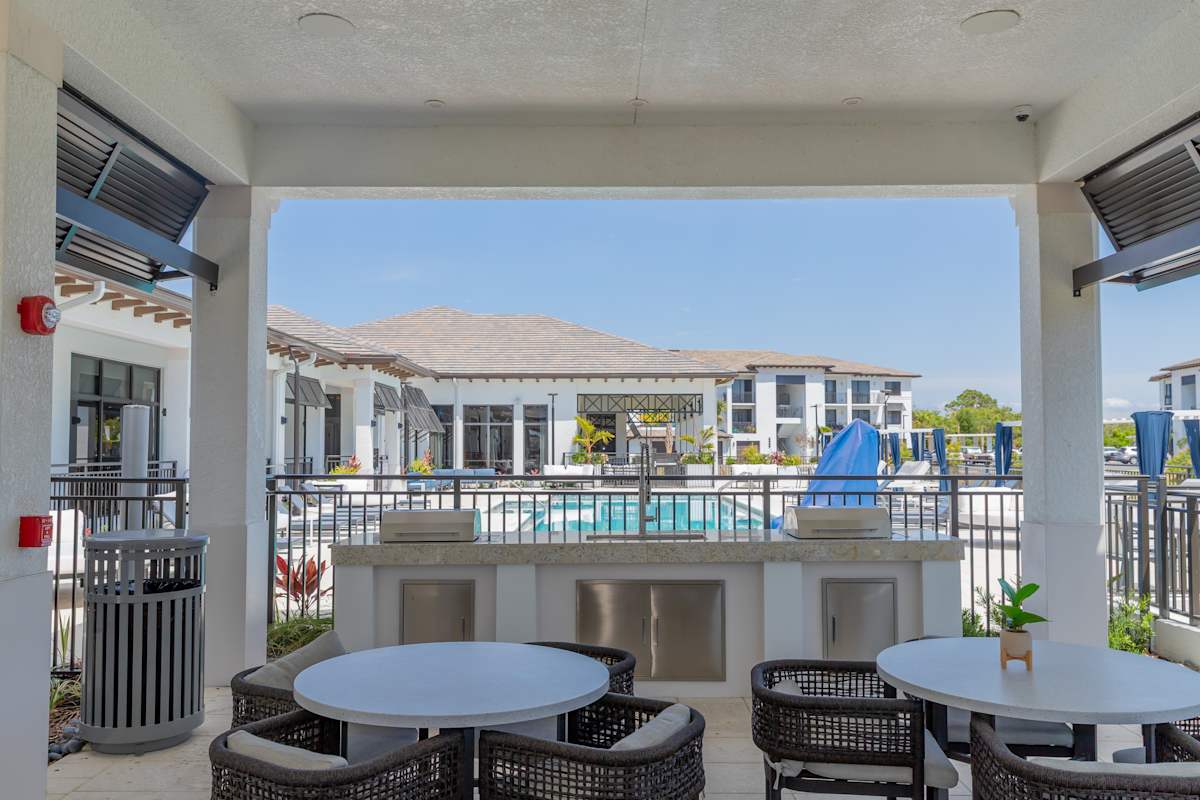 A patio with a table and chairs overlooking a pool at Portofino Vineyards, Fort Myers