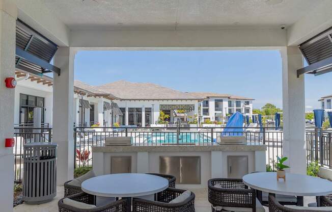 A patio with a table and chairs overlooking a pool at Portofino Vineyards, Fort Myers
