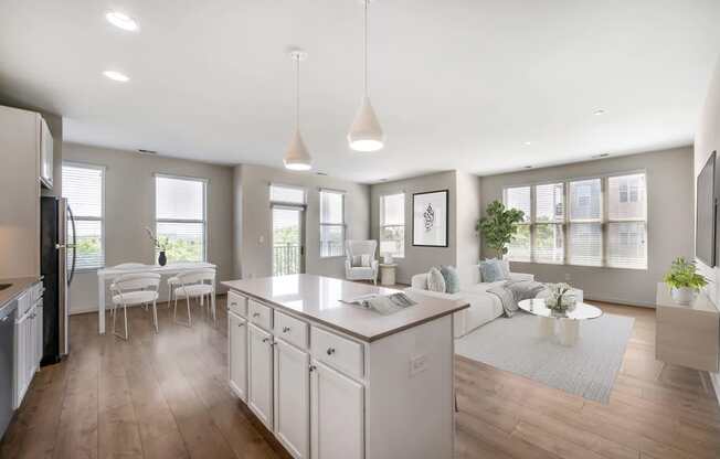 an open kitchen and living room with a white counter top