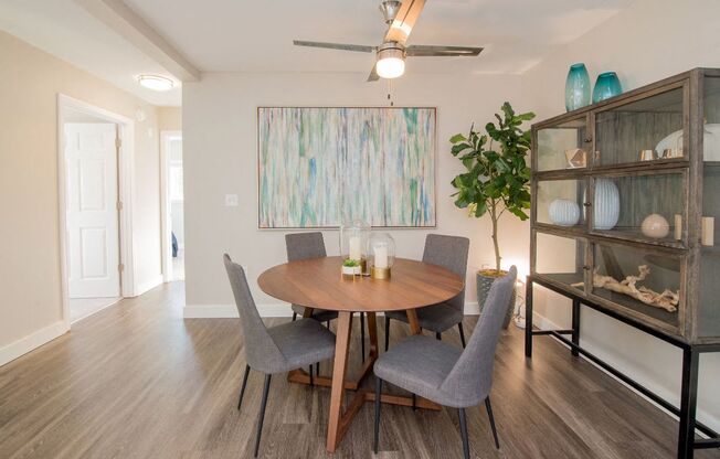 a dining room with a table and chairs