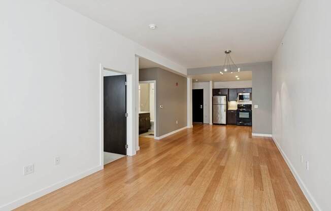 A room with wooden floors and white walls.