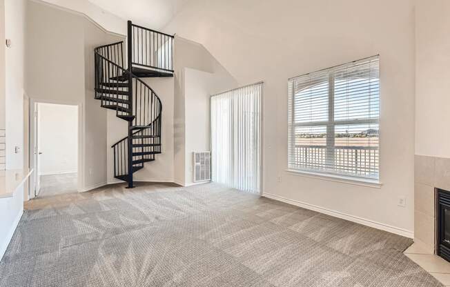 A Living Room with a Spiral Staircase at Fox Run Lofts