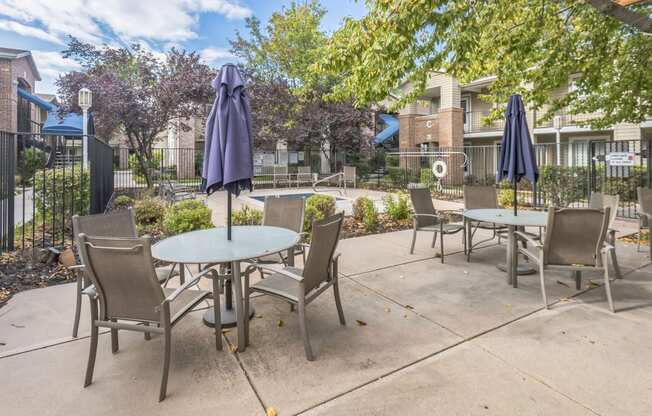 an outdoor patio with tables and chairs and umbrellas