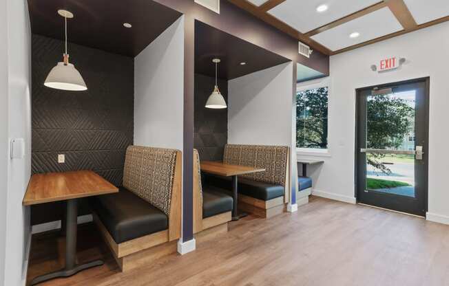 a seating area with two tables and two chairs