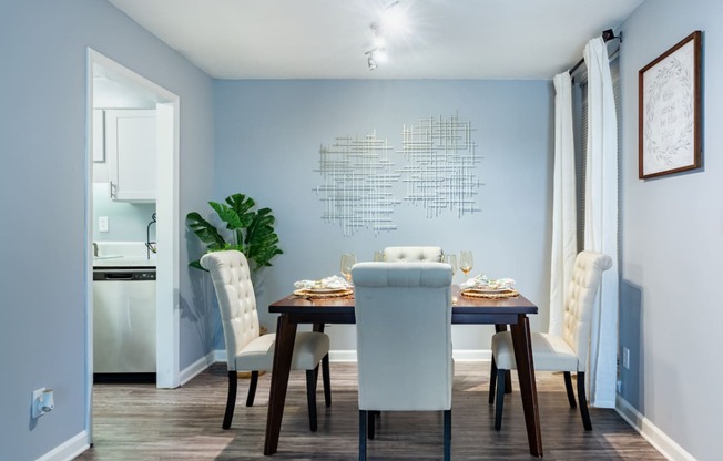 a dining room with a table and chairs