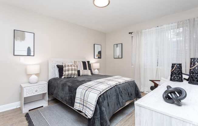 a bedroom with a bed and a white dresser