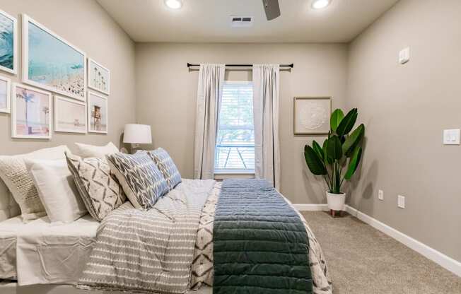 an empty bedroom with a bed and a window