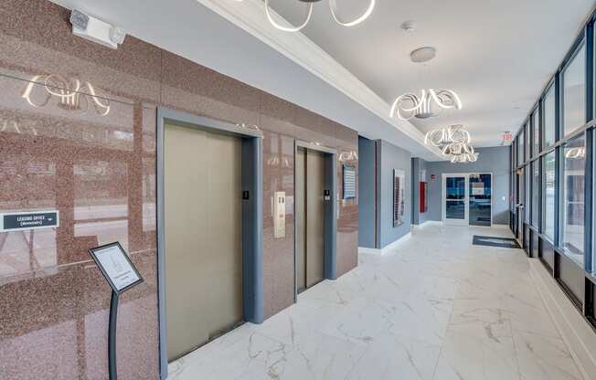 a hallway with elevators and doors in a building