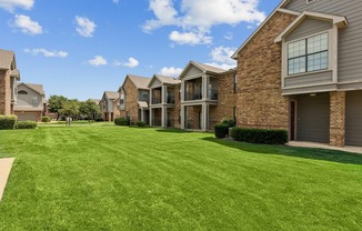 Enclave on Golden Triangle Exterior Image with Views of Apartment Balconies and a Stretch of Green Grass