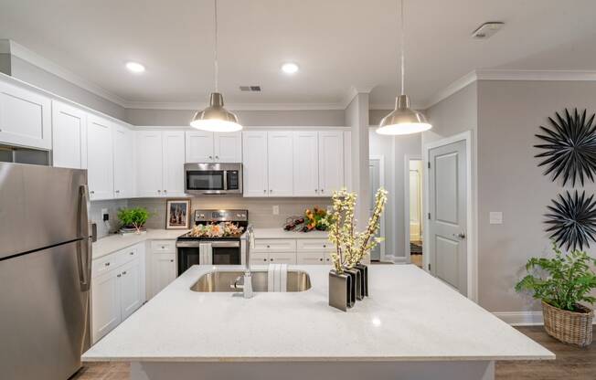 a large kitchen with white cabinets and a white counter top