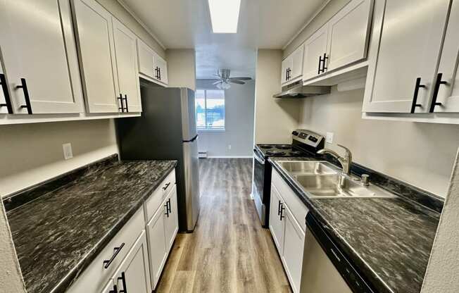 a kitchen with marble counter tops and white cabinets