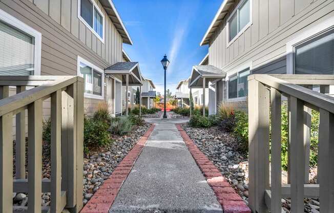 A row of houses with a pathway in between.