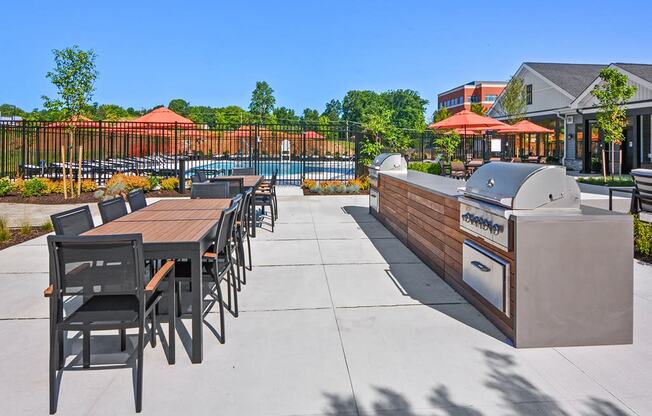 the reserve at city center clubhouse patio with grill and dining table