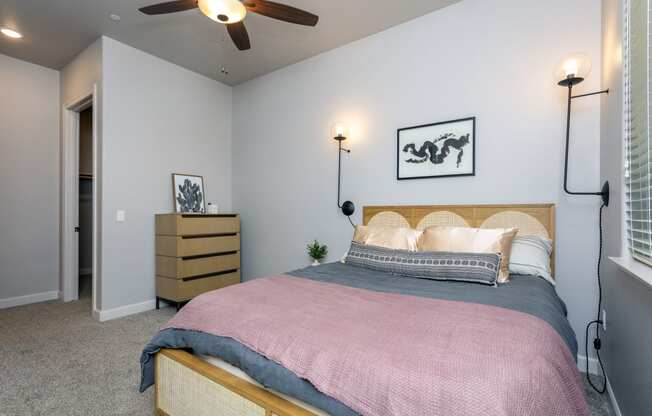 a bedroom with a bed and a ceiling fan