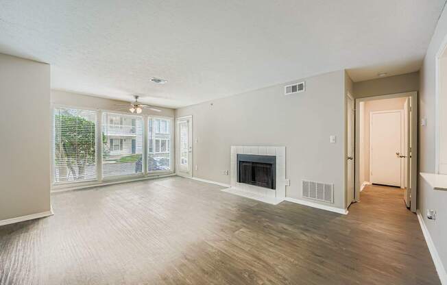 A spacious living room with a fireplace and sliding glass doors.