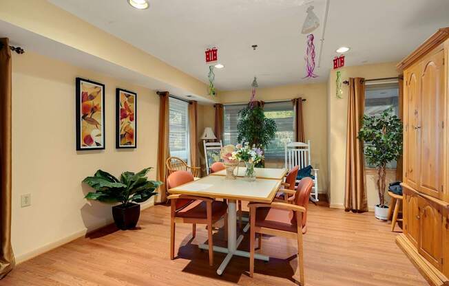a dining room with a table and chairs