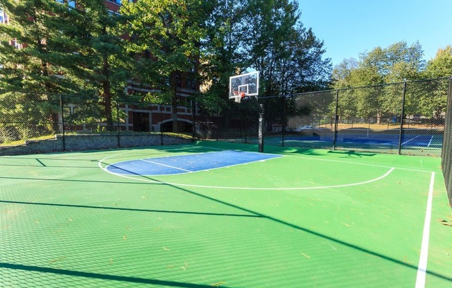 a tennis court with a basketball hoop on it