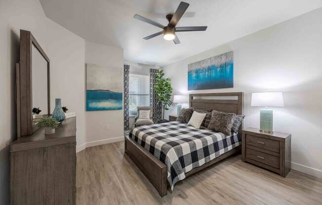 a bedroom with a bed and a ceiling fan