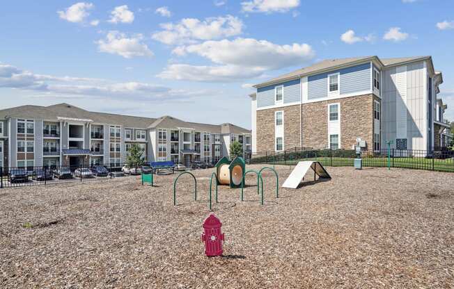 a playground with a fire hydrant in front of an apartment building