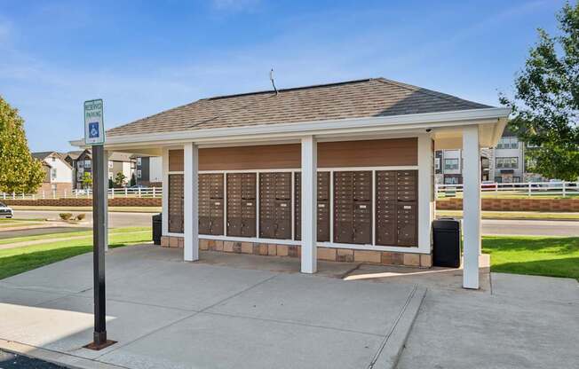 A covered waiting area with a sign for disabled parking.