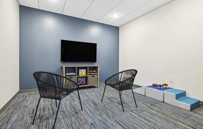 a room with two chairs and a table with a television on top of it