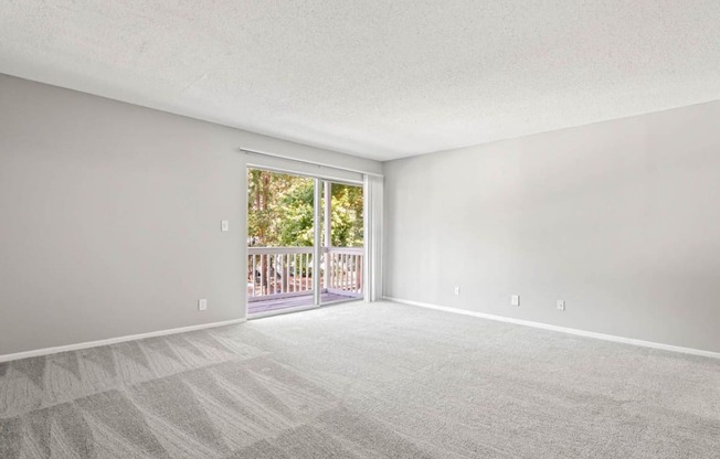 a bedroom with a sliding glass door leading to a balcony