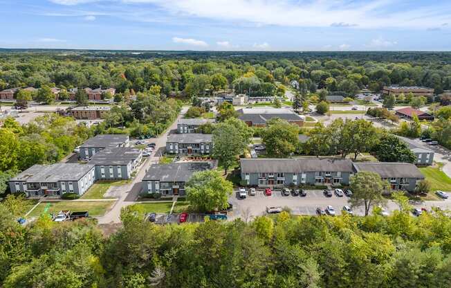 A bird's eye view of a residential area with houses and cars.