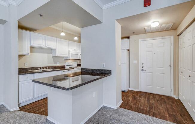 a kitchen with white cabinets and a counter top