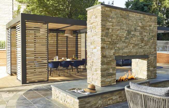 a stone fireplace and a dining area with a table and chairs