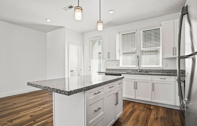 a kitchen with white cabinets and a counter top  at Aero Luxury Townhomes in Layton, Utah