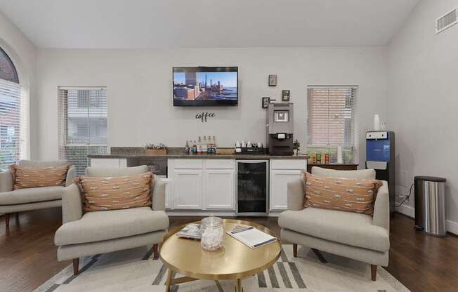A living room with a couch, a coffee table, and a television.