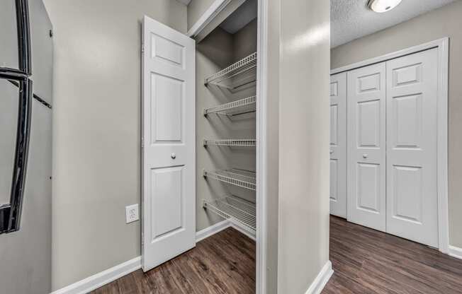 the closet in a new home with white closets and white doors