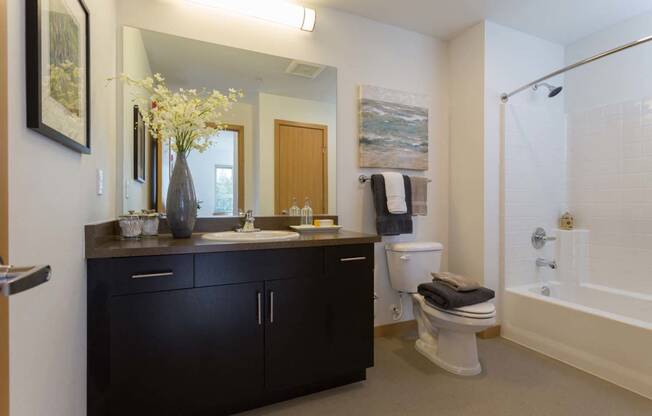 Large Soaking Tub In Master Bathroom With A Tile Surround at Tivalli Apartments, Lynnwood