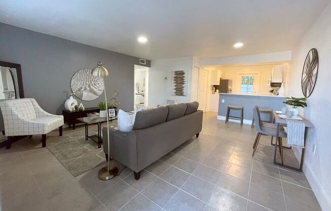 a living room and dining room with a couch and a table