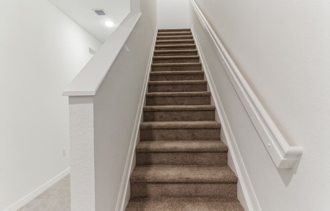 Boatman Hammock Townhomes in Lake Worth, FL photo of an image of a staircase with carpeted stairs and white railings