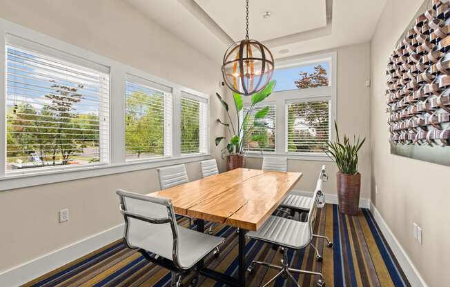 a dining room with a table and chairs and windows