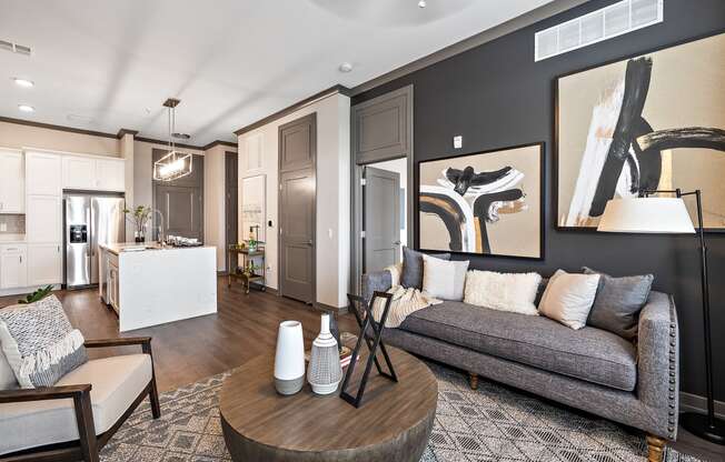 a living room with a gray couch and a wooden coffee table at The Griffin Royal Oak, Royal Oak, Michigan